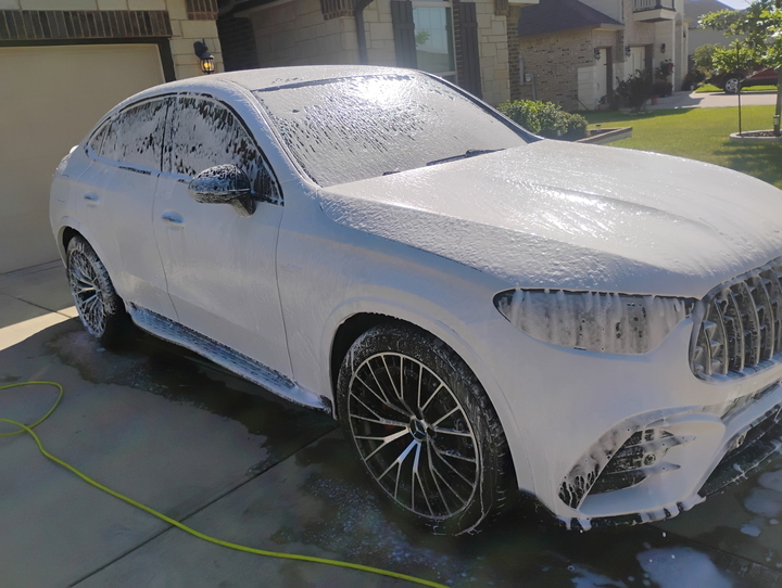 White Mercedes covered in foam partway through a hand wash