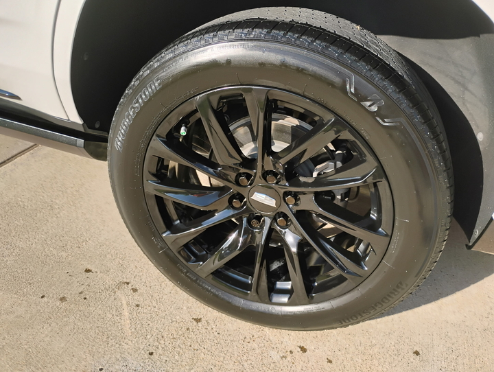 Freshly detailed glossy wheel and tire, finished by hand
