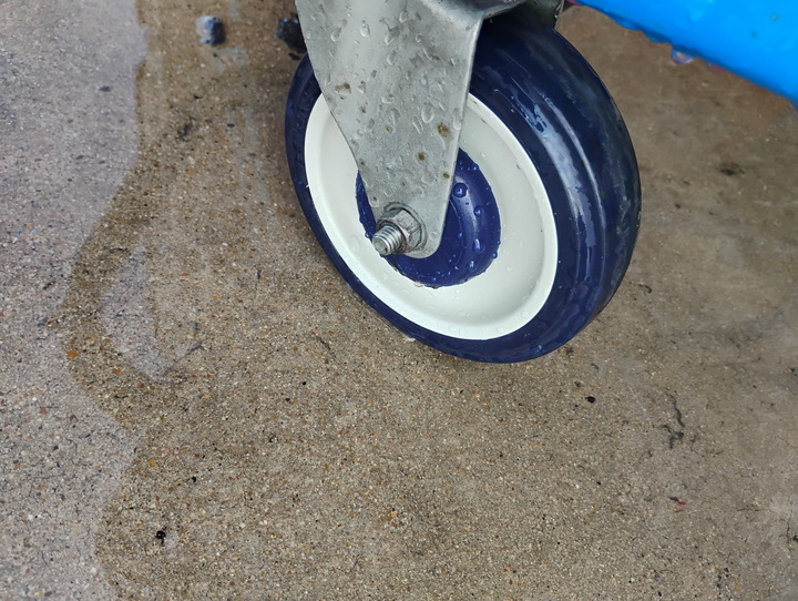 Shopping-cart caster wheel scrubbed clean