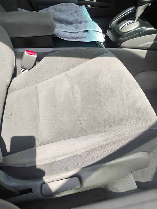 Cloth seat being deep-cleaned during an interior detail